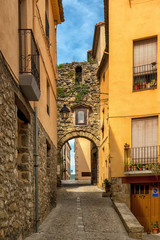 Narrow street with arch at end in medeival town of Besalu
