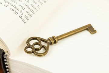 Antique key on book page