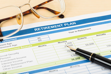 Retirement plan with glasses, and pen, document is mock-up