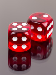 Two red dice with reflection