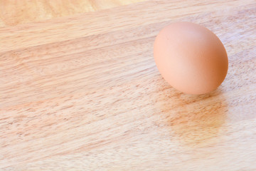 egg placed on wooden table