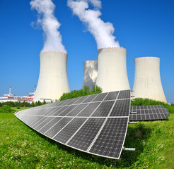 Solar energy panels before a nuclear power plant