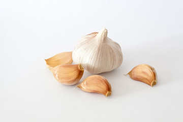 Bulbs of garlics on white background.