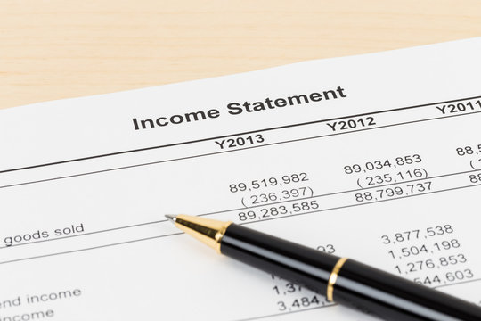 Income statement financial report with pen