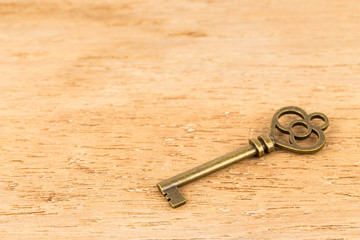 Antique key on wooden background