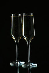 Glasses of champagne on a black background