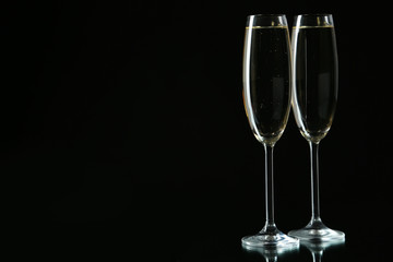 Glasses of champagne on a black background