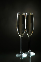 Glasses of champagne on a black background