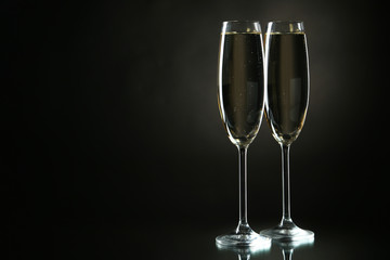 Glasses of champagne on a black background