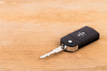 Modern remote car key on wooden background