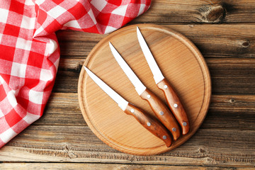 Set of kitchen knifes on brown wooden background