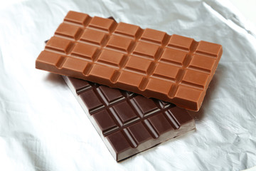 Dark and milk chocolate bar on foil