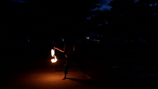 Fire show artist twists fire