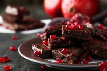 Homemade chocolate fudge with pomegranate on plate