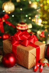 Fototapeta na wymiar Christmas balls and Christmas gift on grey wooden background