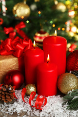 Obraz na płótnie Canvas Christmas balls and candles on grey wooden background