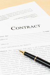 Business contract with pen; document is mock-up