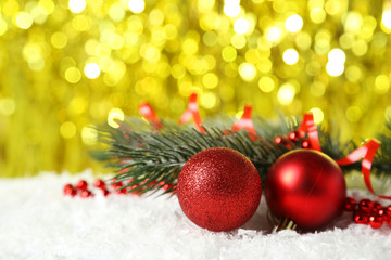 Fototapeta na wymiar Branch of Christmas tree with balls on snow