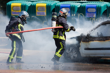 Two firefighters in action