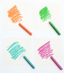 Set of colorful crayons on piece of white paper