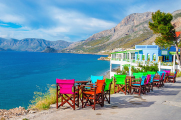 Colorful wooden tables and chairs on Greek Island