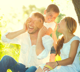 Happy joyful young family having fun outdoors