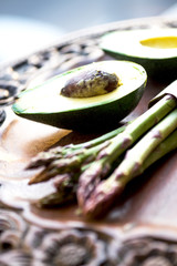 Bunch of fresh asparagus and avocado on wooden table
