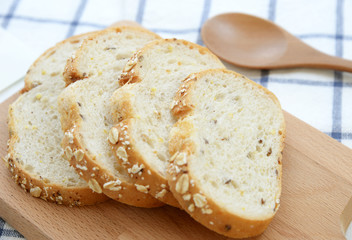 Sliced white bread on wooden plate