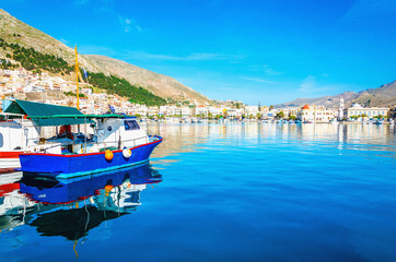 Blue wooden boat moored in peaceful port