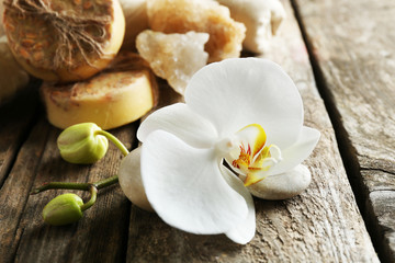 Still life with beautiful blooming orchid flower, spa treatment on wooden background