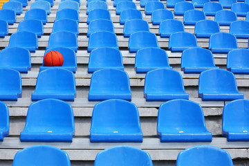 Naklejka premium Basketball ball on stadium seat