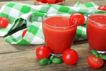 Glasses of tomato juice with vegetables on table close up