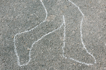 Chalk outline of body dead on pavement
