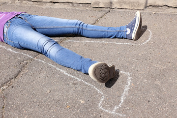 Dead woman laying on asphalt