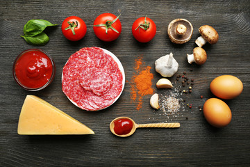 Ingredients for cooking pizza on wooden table, top view