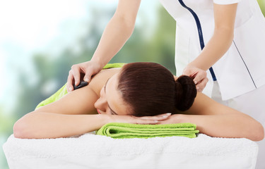 Obraz na płótnie Canvas Woman getting stone massage in spa.