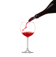 red wine pouring into wine glass isolated