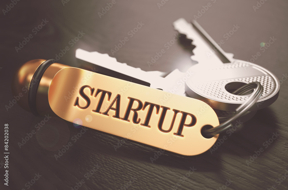 Aufkleber startup - bunch of keys with text on golden keychain.