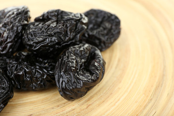 Pile of prunes on wooden background