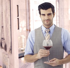 Elegant man with glass of wine at Paris retro home