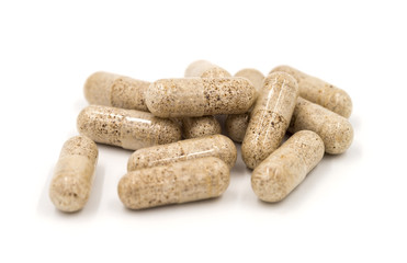 Herb capsules isolated on white background (Medical)