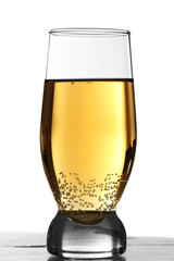 Glass of water with bubbles on table isolated on white