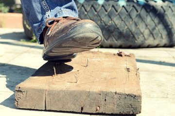 Worker steps on nail outdoors