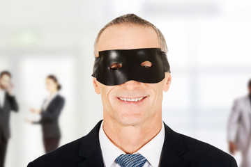 Businessman wearing black eye mask