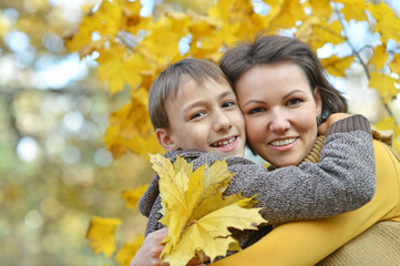 Mother with boy in autumn park