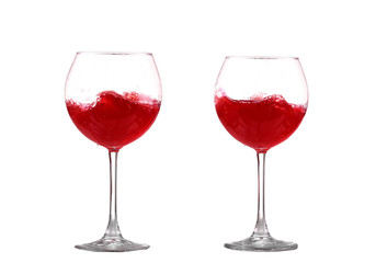 red wine splashing in a glass, isolated on white