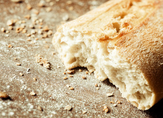 Broken open freshly baked golden baguette