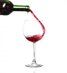Fotobehang red wine pouring into wine glass isolated on a white background © YURII Seleznov