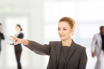 Businesswoman pointing away.
