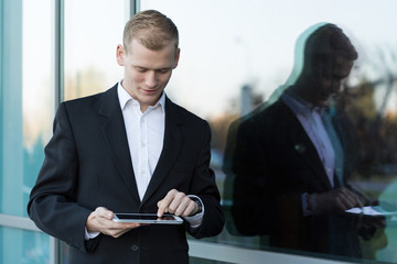 Handsome businessman with a tablet